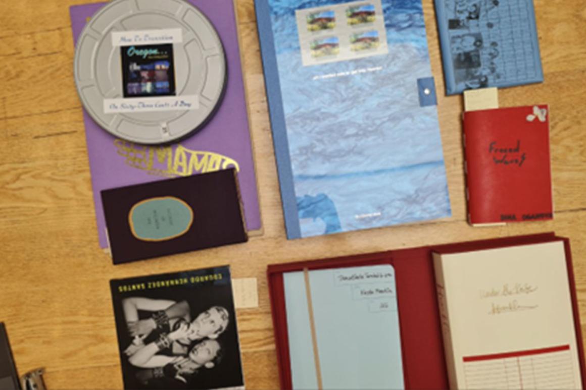 Image of many artists’ books laid out of various shapes, sizes, and colors.