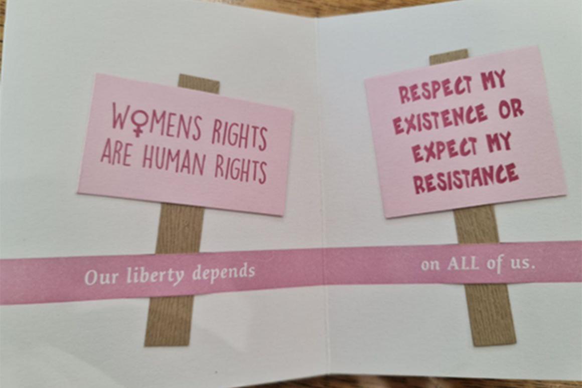 Image of an artists’ book page with cut out paper signs that read, “Women’s Rights Are Human Rights,” and “Respect My Existence or Expect my Resistance.”