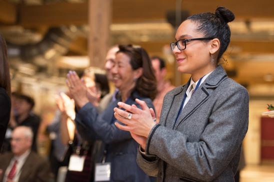 woman clapping at an event